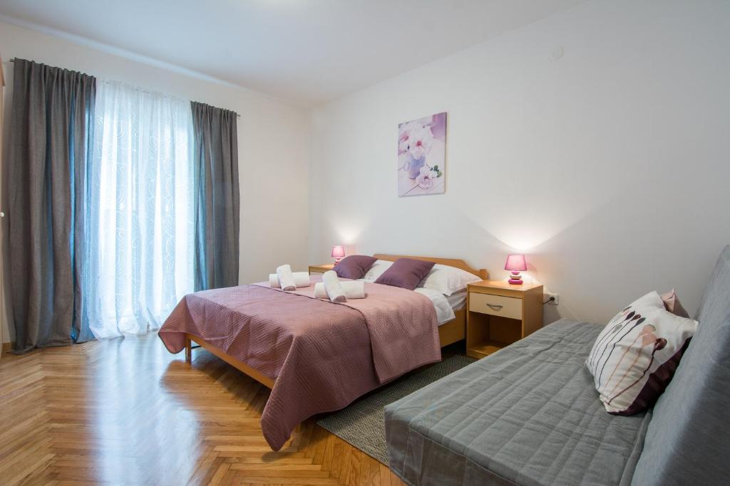 Posteľ alebo postele v izbe v ubytovaní Melita Center Apartment