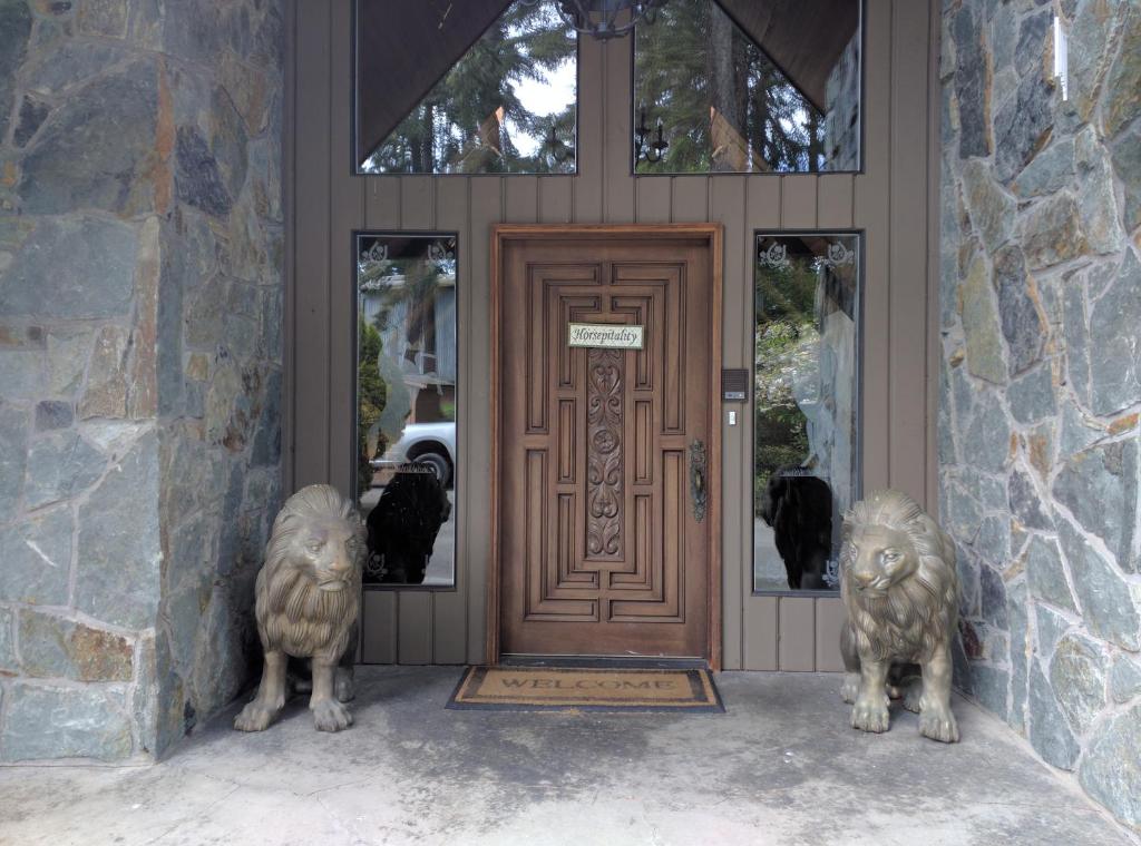 two statues of lions standing in front of a door at Wildwood Farm Bed & Breakfast in Oak Harbor