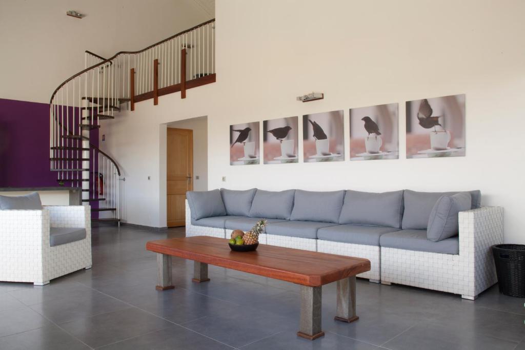 a living room with a couch and a table at La Canne A Sucre in Sainte-Anne