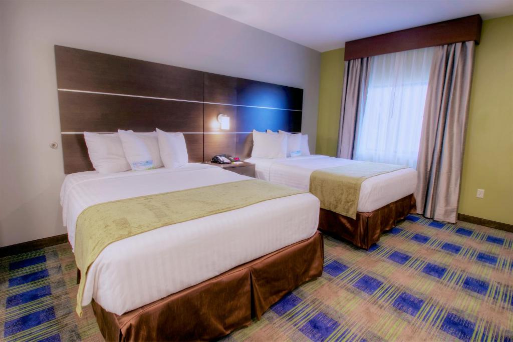 Postel nebo postele na pokoji v ubytování Days Inn & Suites by Wyndham Port Arthur