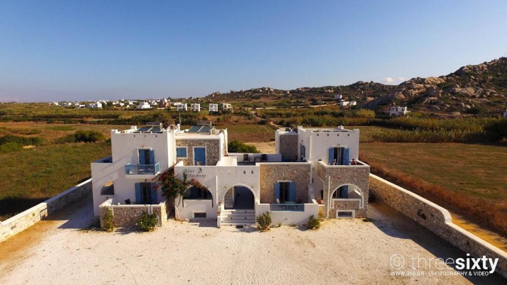 an aerial view of a white house in a field at Blue Harmony Apartments in Plaka