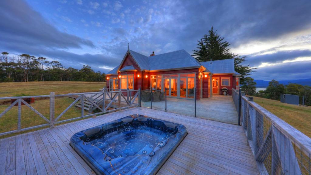 a house with a hot tub on a deck at The Peninsula Experience in Dover