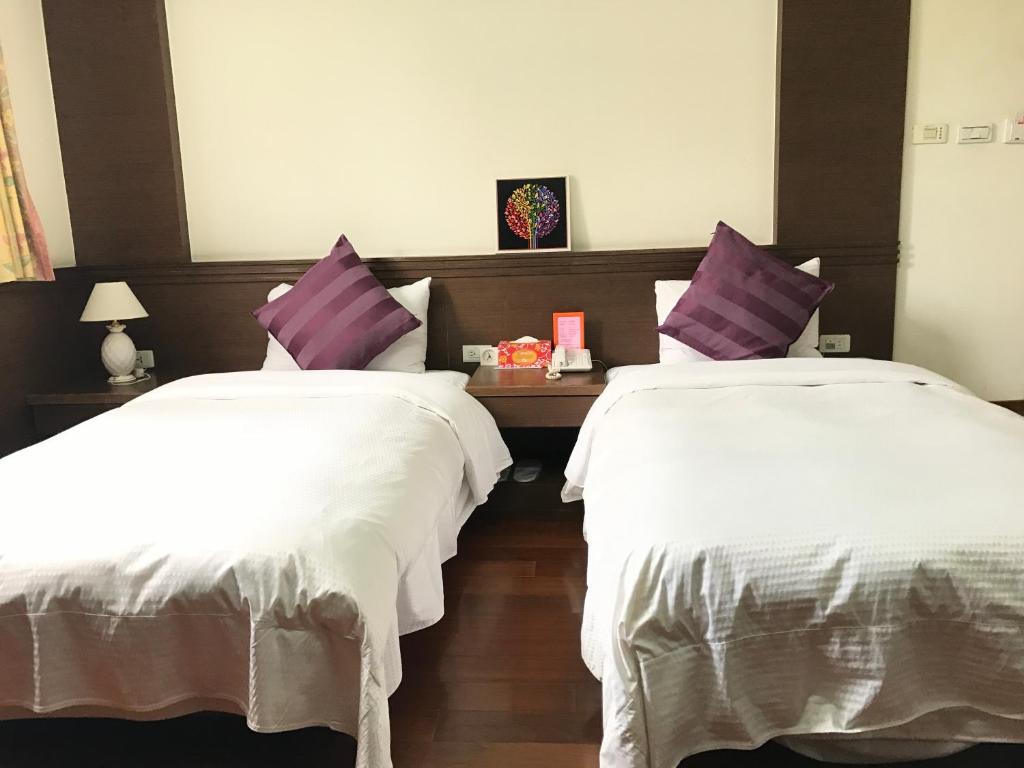 Postel nebo postele na pokoji v ubytování Fu Chang Hotel