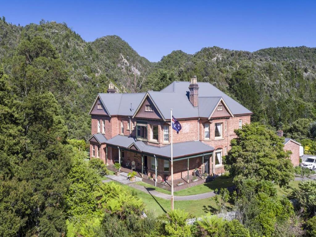 an aerial view of a large brick house in the mountains at Penghana Bed and Breakfast in Queenstown