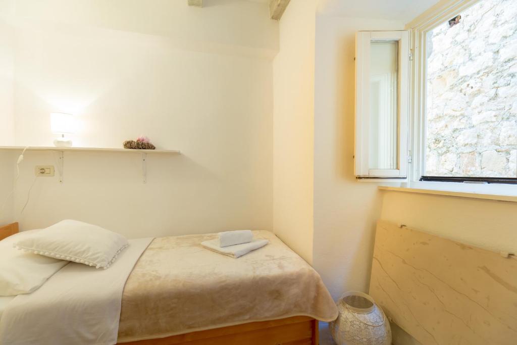 Postel nebo postele na pokoji v ubytování Apartment Hedera A11