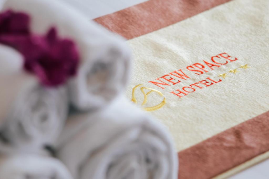 a napkin with the words new angel hotel on it at New Space Hotel Airport in Ho Chi Minh City