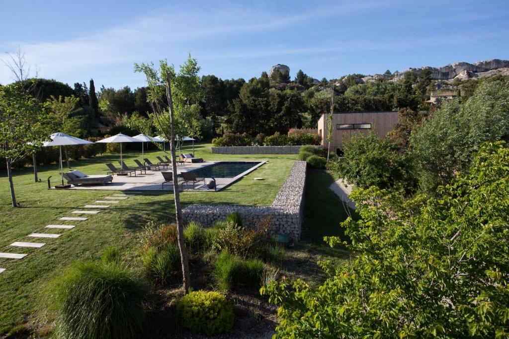 un jardin avec une piscine et un complexe dans l'établissement Domaine Mejan, à Paradou