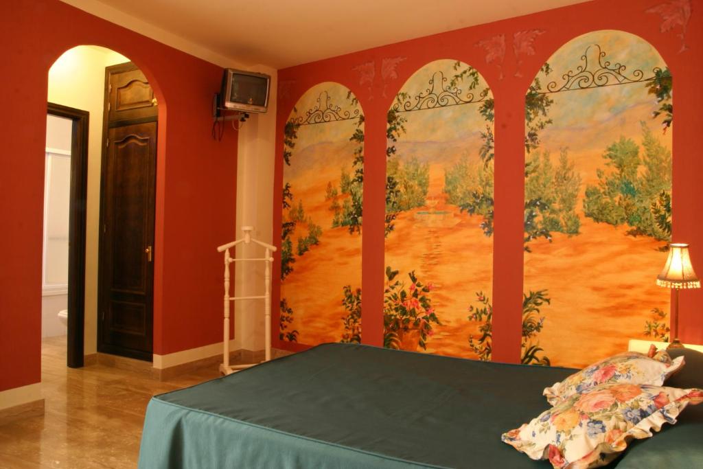 Łóżko lub łóżka w pokoju w obiekcie Hotel Las Rosas