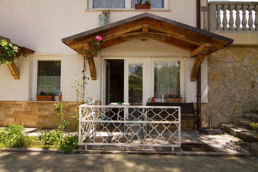 a gate in front of a house with a wooden entrance at Apartments Olga in Bled