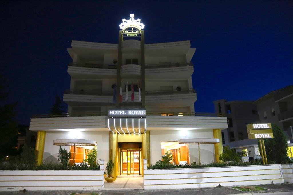 a white building with a clock on top of it at Hotel Royal in Vasto