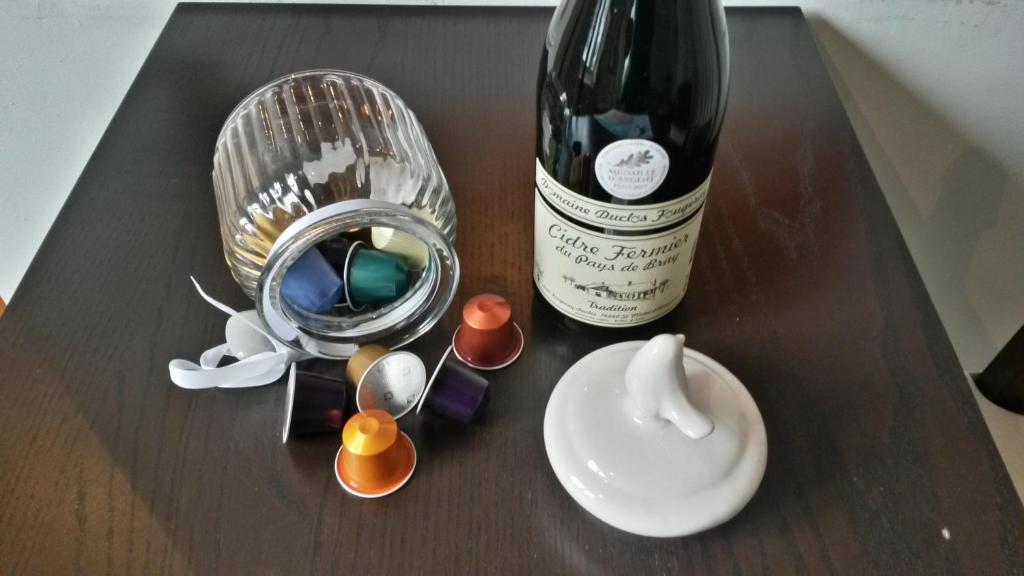 - une bouteille de vin, des verres à vin et une bouteille de vin dans l'établissement La Petite Fugue, à Honfleur