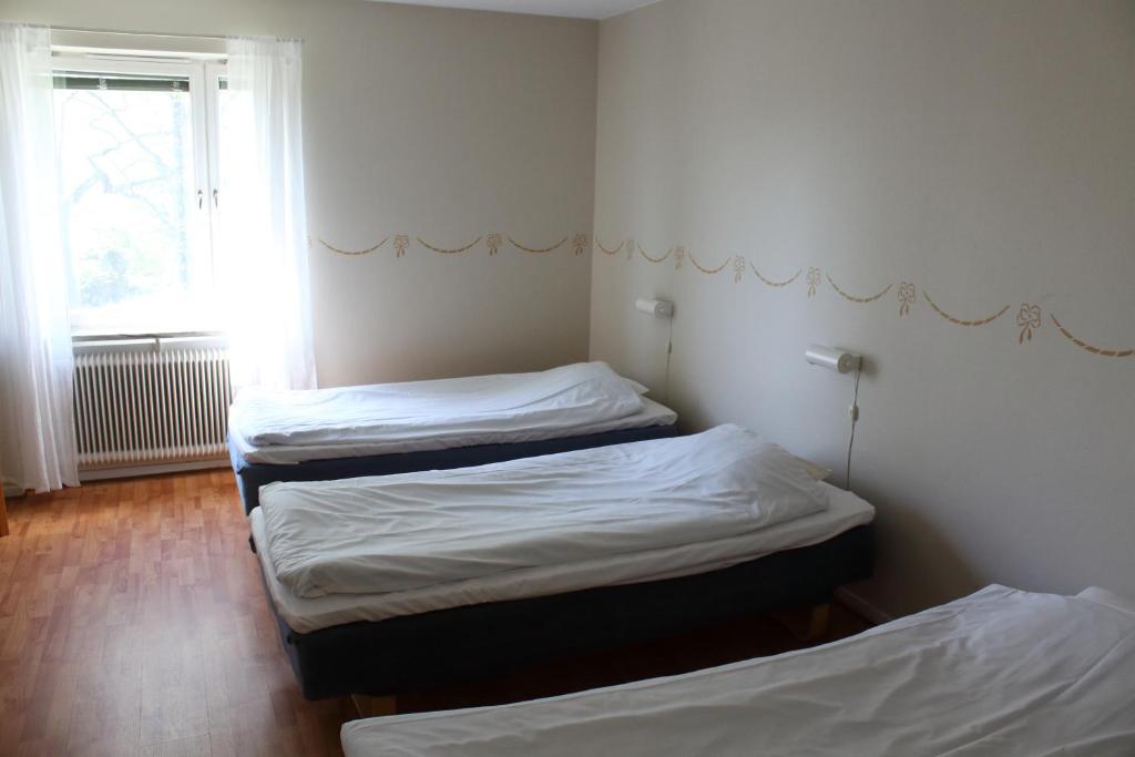 Postel nebo postele na pokoji v ubytování Ekbackens Vandrarhem