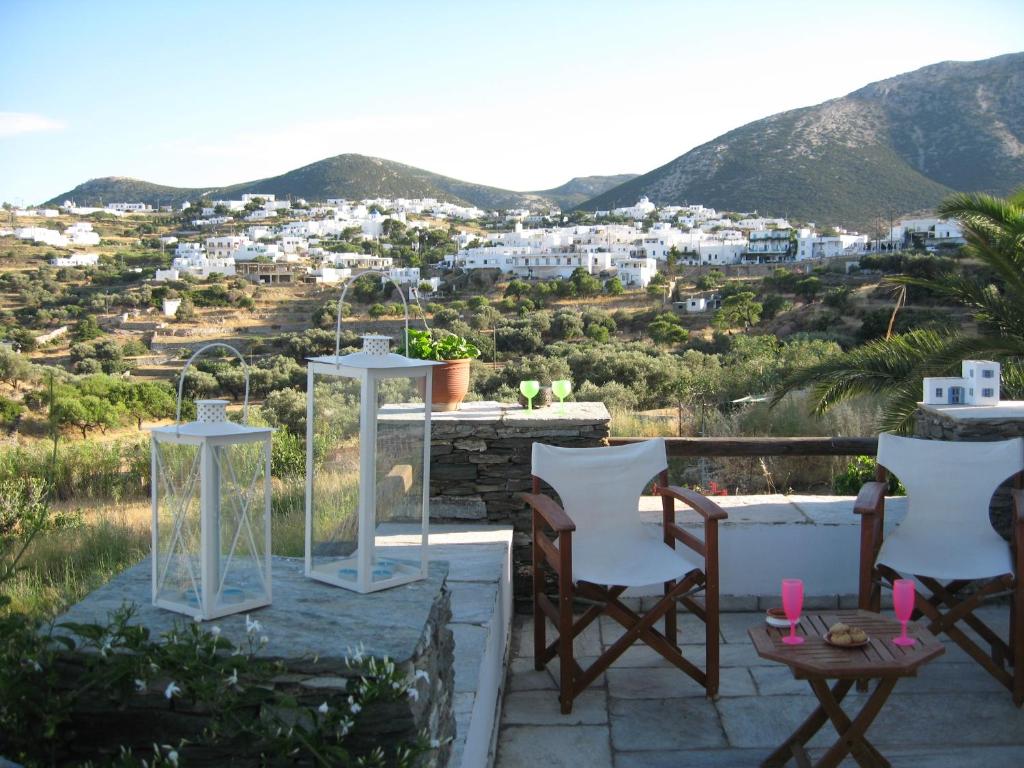 a patio with chairs and a view of a city at Apollon-Artemis Apartments in Apollonia