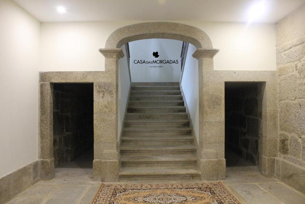 a staircase in a building with a sign on the wall at Casa Das Morgadas in Nelas