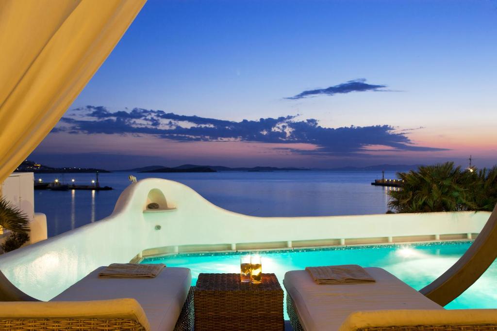 
a hotel room with a view of the ocean at Harmony Boutique Hotel in Mýkonos City

