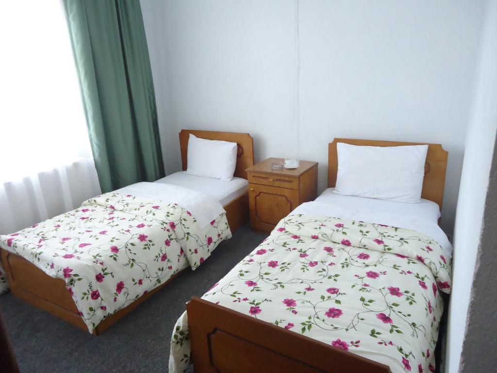 A bed or beds in a room at Akar Hotel