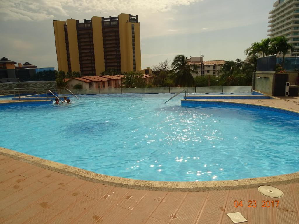 a large swimming pool with people in the water at Tayrona Beach Bello Horizonte in Santa Marta