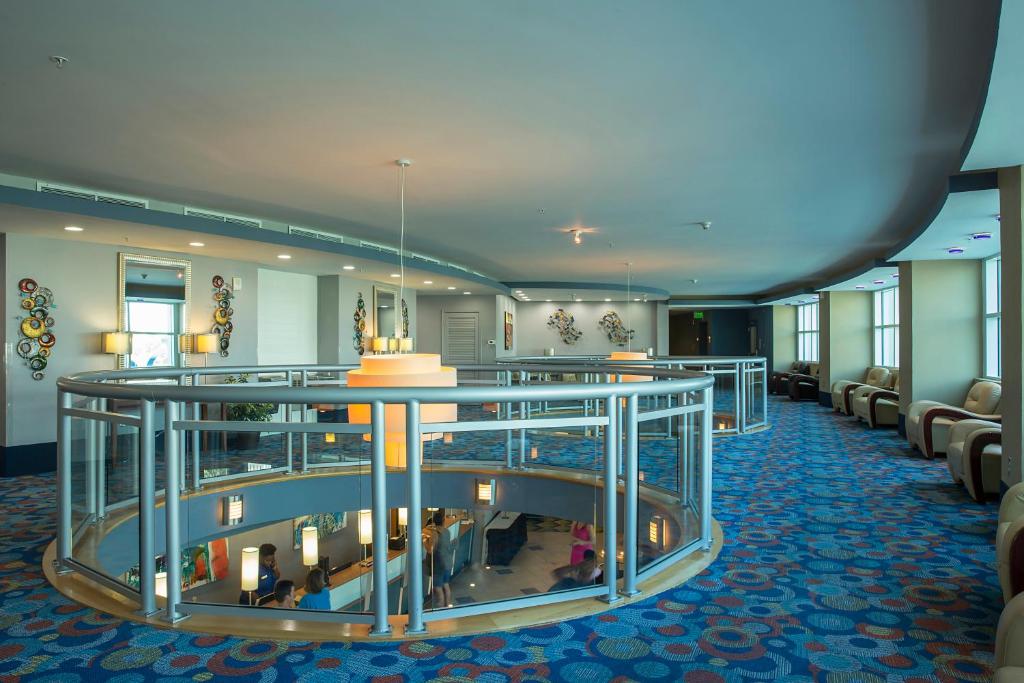 a lobby of a hotel with chairs and a bar at Avista Resort in Myrtle Beach