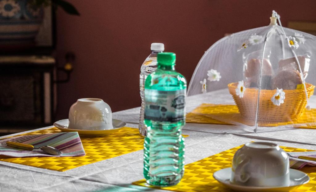 a bottle of water sitting on top of a table at Margherita Friendly house in Almè