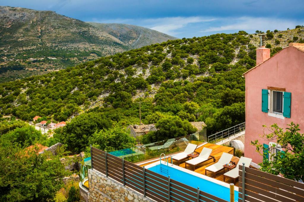 a villa with a swimming pool and a mountain at Iconic Villas - Villa Vada in Ayia Evfimia