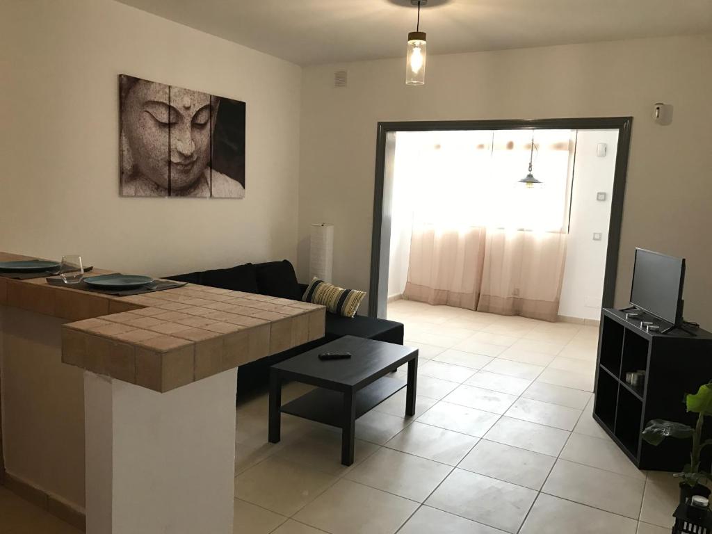 a living room with a table and a couch at New cozy flat with pool in amazing place..! in Costa Del Silencio