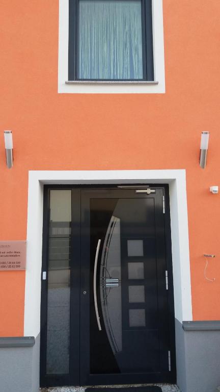 a building with a black door in front of it at Die Schlafstube - Bed & Breakfast in Zeltweg