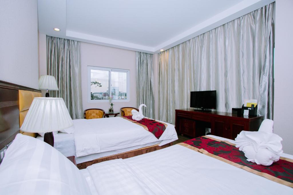 Postel nebo postele na pokoji v ubytování Palawan Uno Hotel
