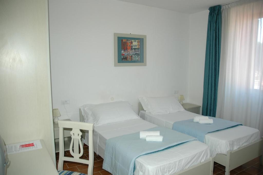 Postel nebo postele na pokoji v ubytování Albergo Dei 10 Colori