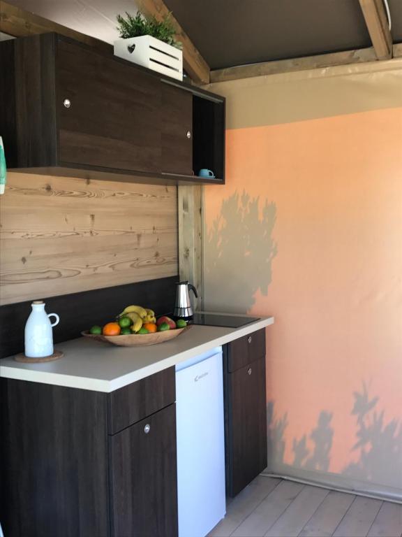 a kitchen with a plate of fruit on the counter at New Camping Le Tamerici in Marina di Cecina