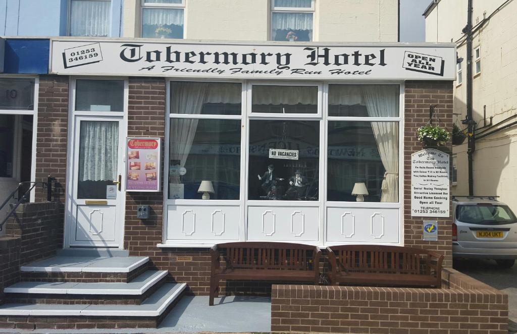 a store with a bench in front of a building at Tobermory Hotel in Blackpool