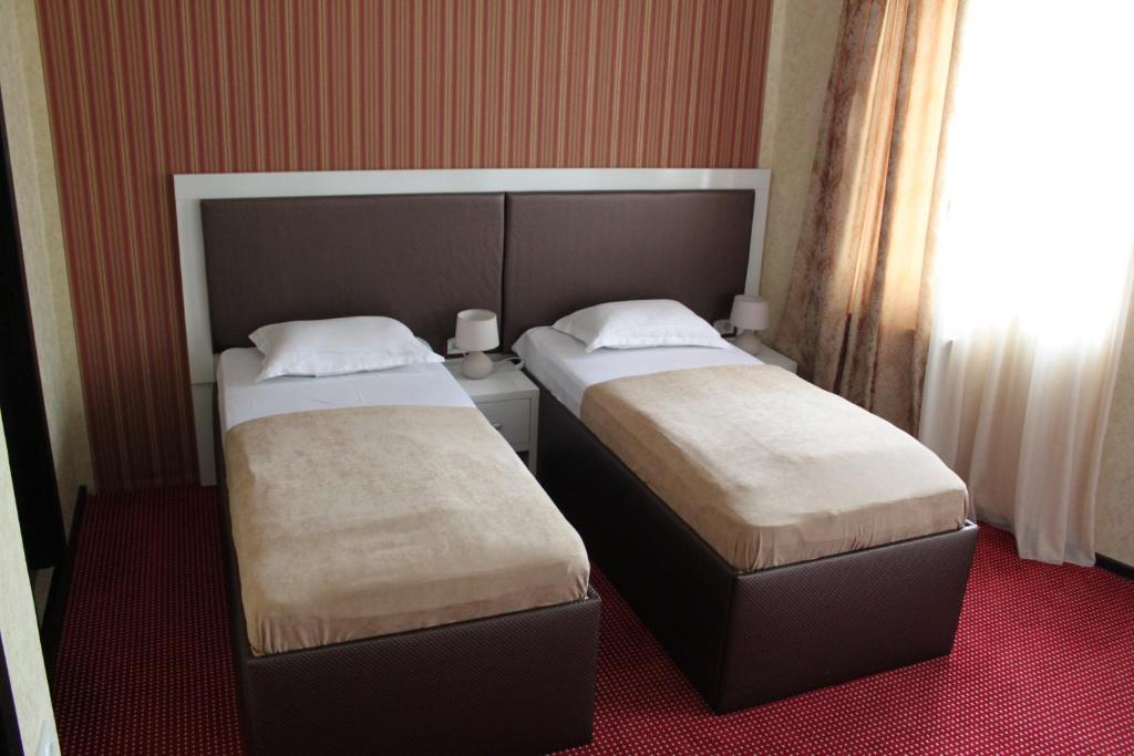 Postel nebo postele na pokoji v ubytování Hotel Avlabari