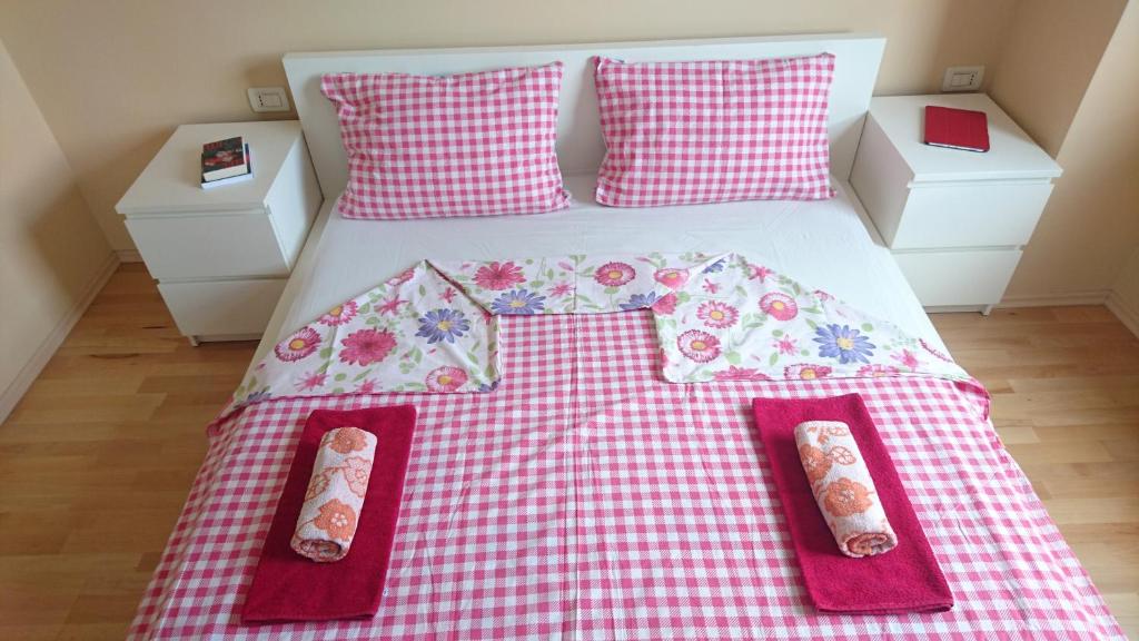 a bed with a red and white checkered blanket at Apartment Vladka Koper in Koper