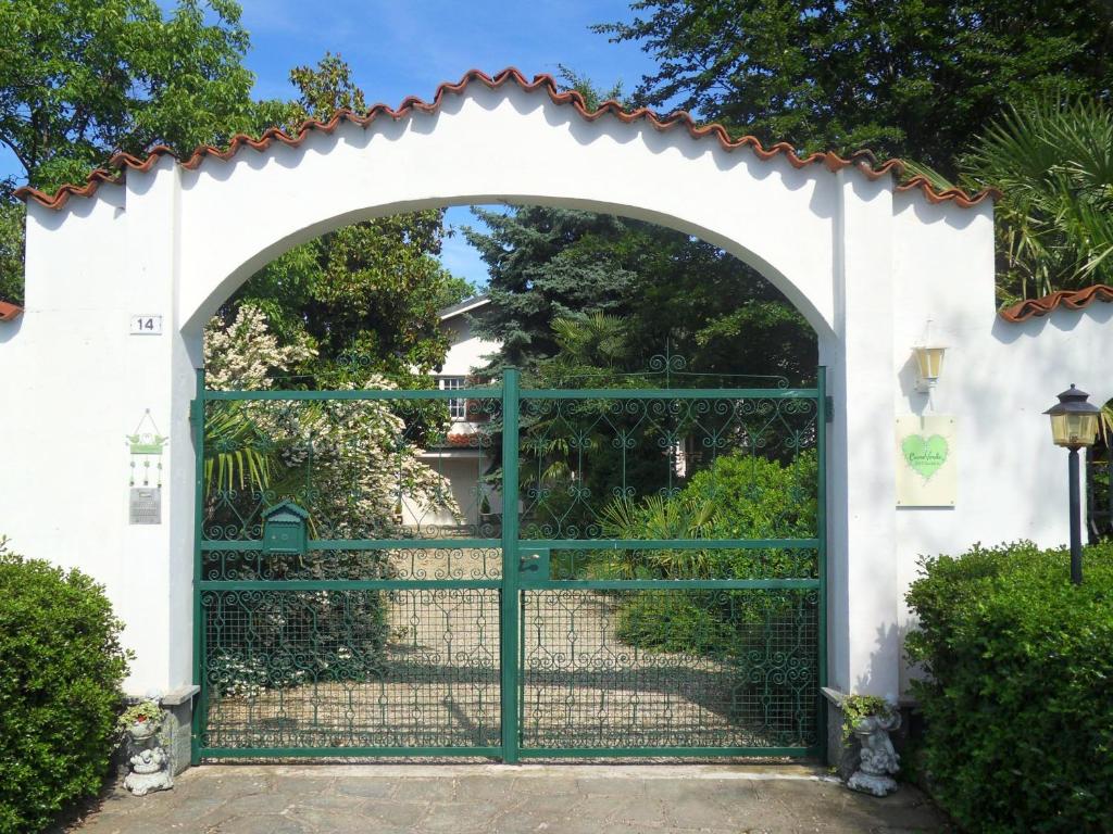 カヴールにあるCuore Verdeの緑の柵のある別荘の入口