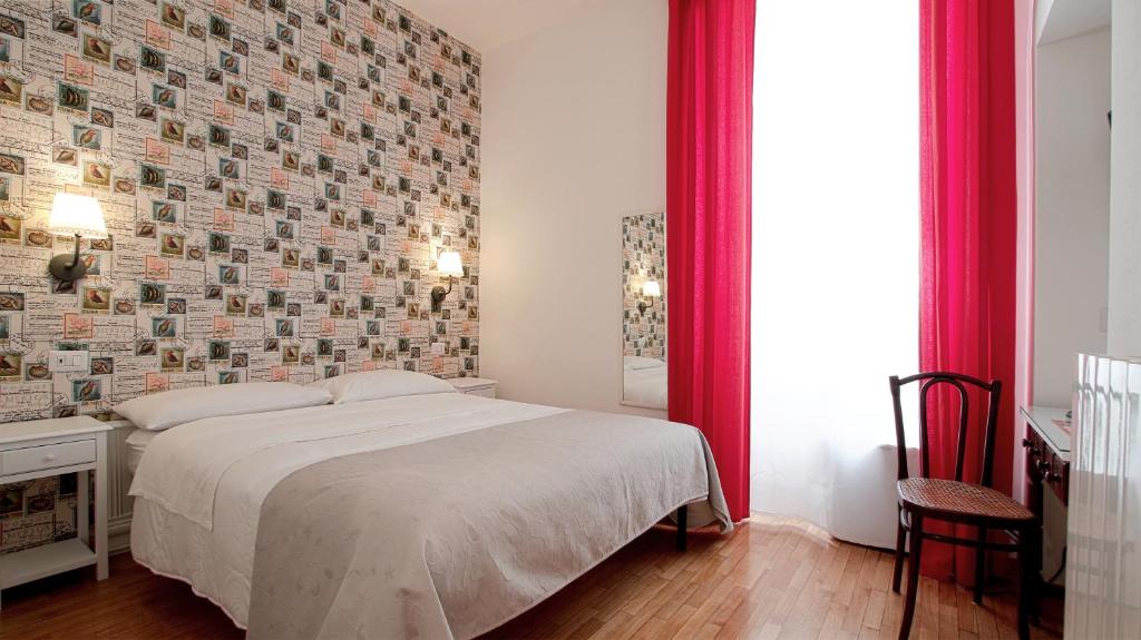 a bedroom with a bed and a brick wall at Domus Flaviae in Rome