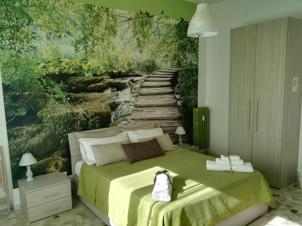 a bedroom with a bed with a painting of a bridge at La Finestra Sul Mondo B&B in Rome