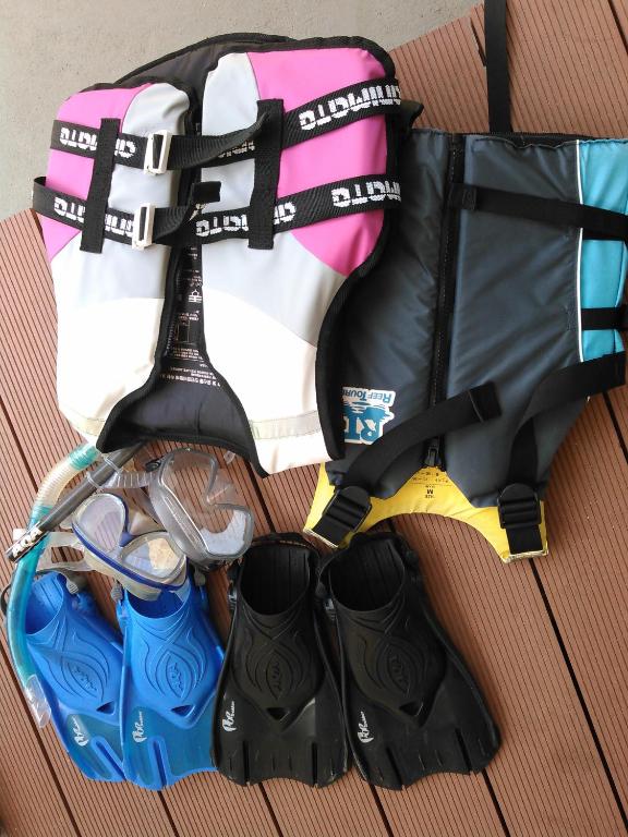 a bag with shoes and other items on a table at Guest House Miyakojima in Miyako-jima
