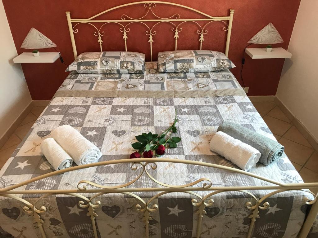 a bedroom with a bed with a quilt on it at Il Cremino in Tropea