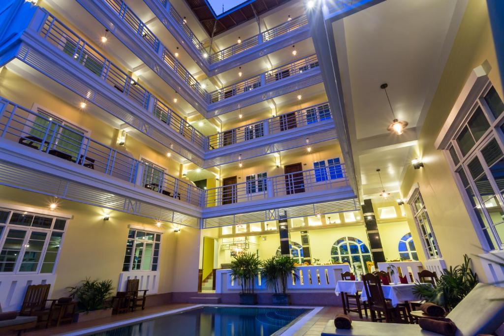a large building with a pool in the middle of it at Grand Bayon Siem Reap Hotel in Siem Reap