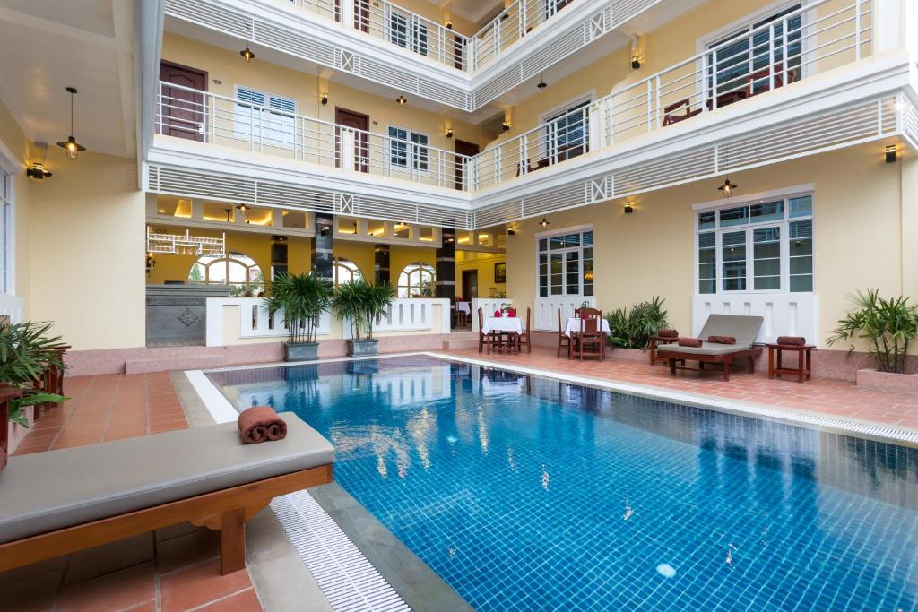 a large swimming pool in a building with a pool at Grand Bayon Siem Reap Hotel in Siem Reap