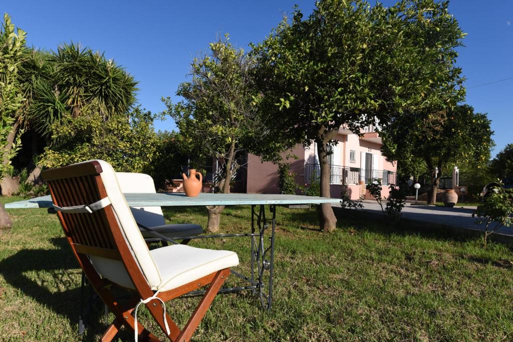 a table with two chairs and a table with a vase on it at Secret Garden in Témeni