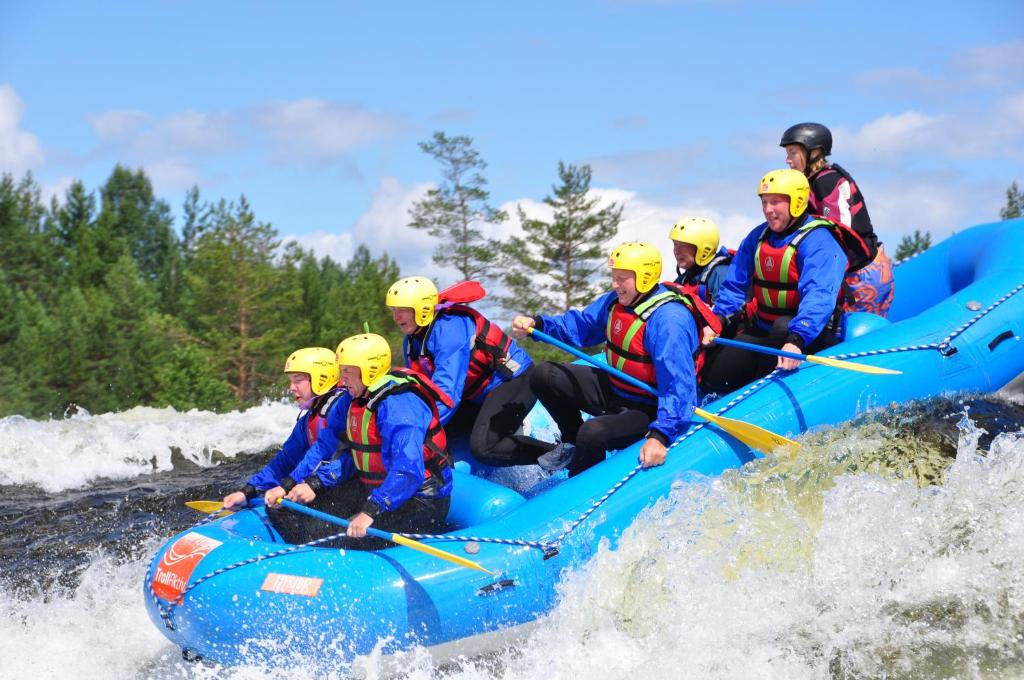 a group of people in a raft on a river at TrollAktiv Evje in Evje