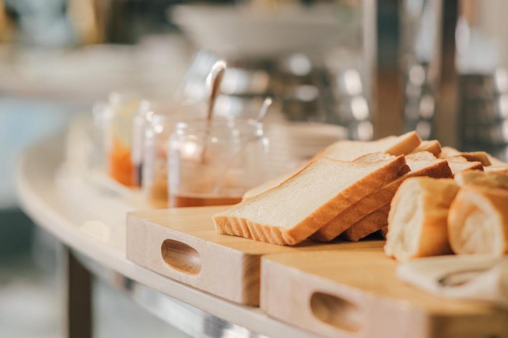 a table topped with slices of bread on a cutting board at New Space Hotel Airport in Ho Chi Minh City