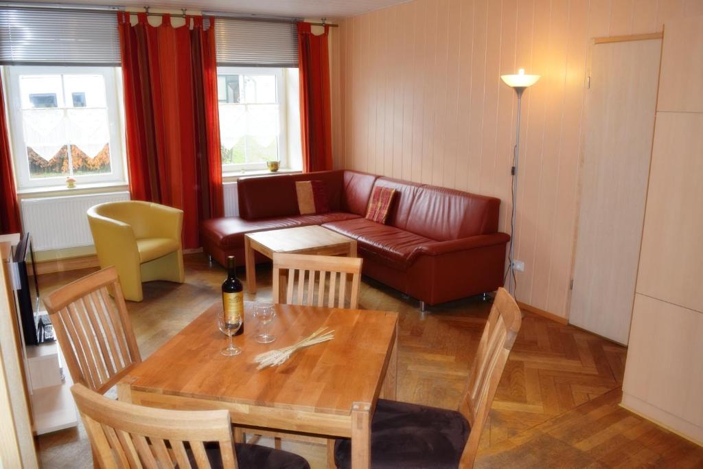 a living room with a table and a couch at Ferienhaus Bendsieferhof in Monschau