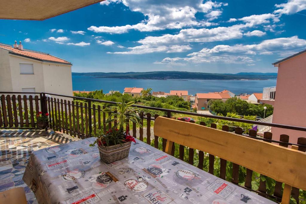 einen Tisch auf einem Balkon mit Blick auf das Wasser in der Unterkunft Apartments Faro & Mondo in Crikvenica