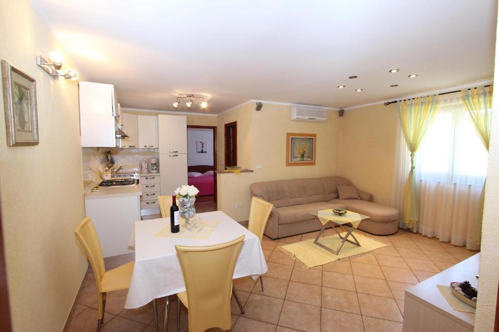 kuchnia i salon ze stołem i kanapą w obiekcie Apartments Pataj w Rovinj