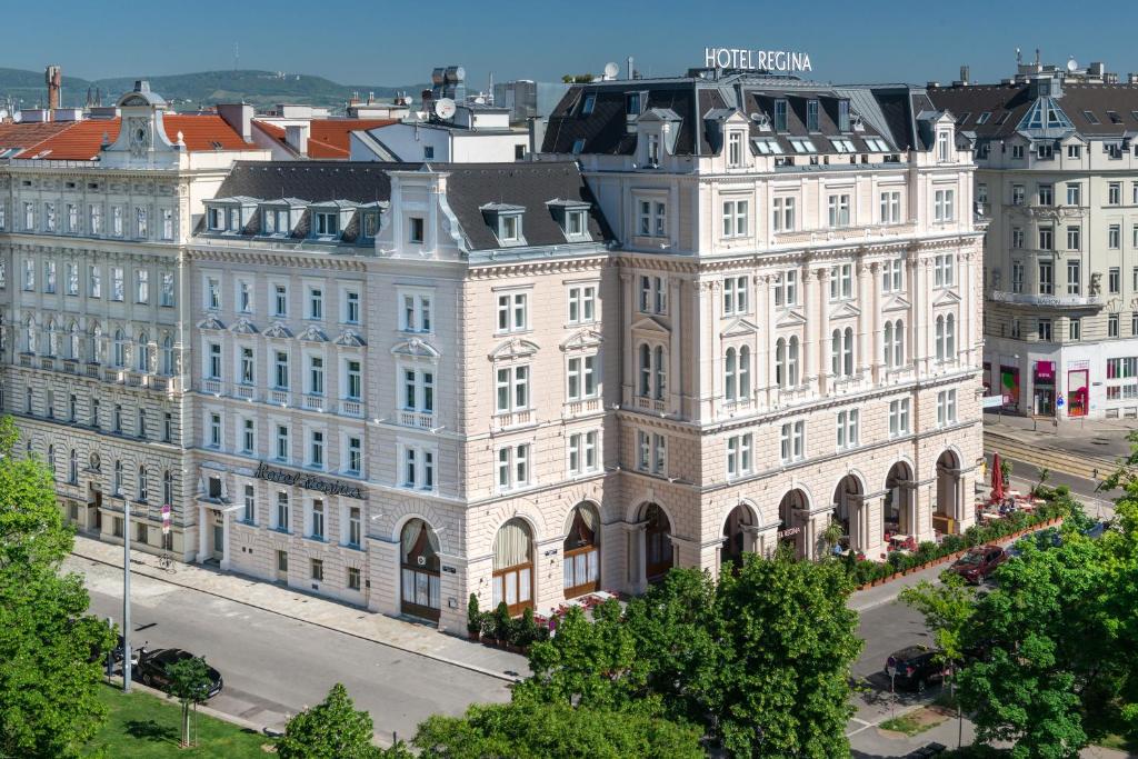 
a large building with a large clock tower on top of it at Hotel Regina in Vienna

