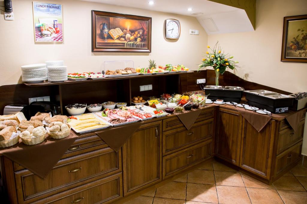 a buffet line with many different types of food at Hotel Maksymilian in Krakow