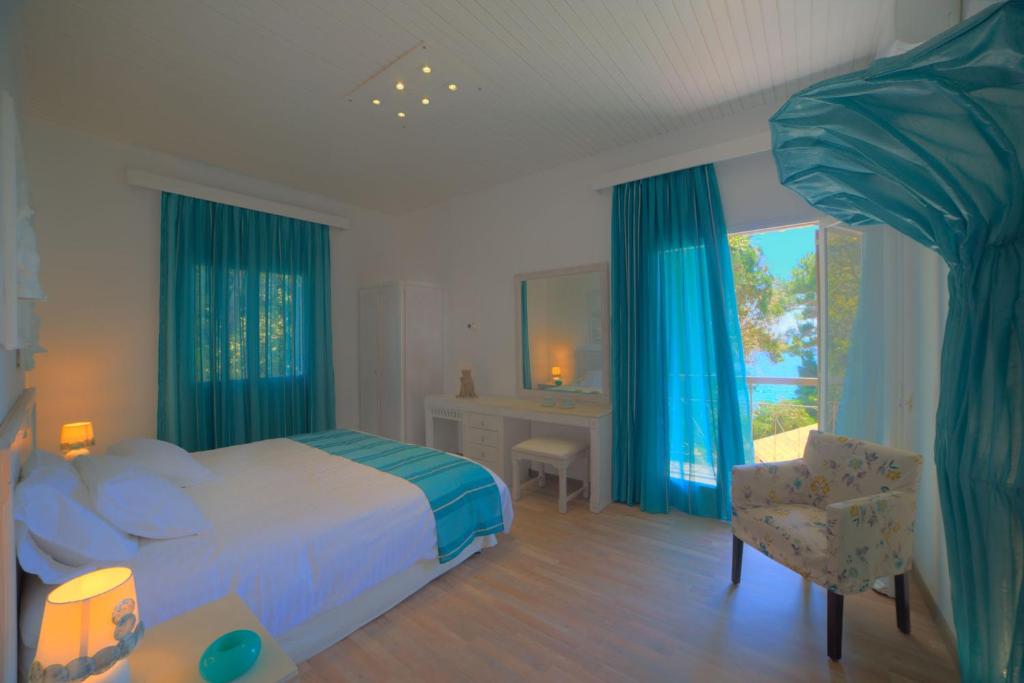 a bedroom with a bed and a desk and a chair at Ionian Paths in Perama