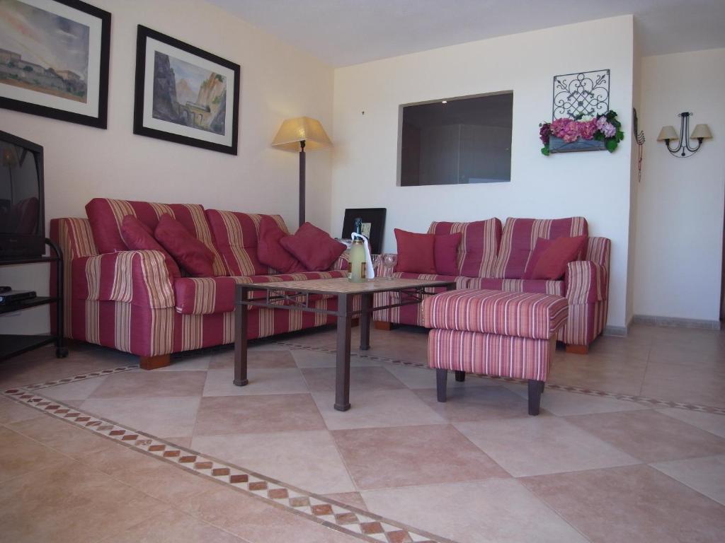 a living room with two couches and a table at Soling 103 in La Manga del Mar Menor
