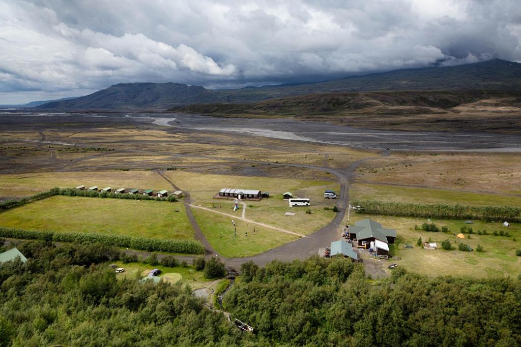 an aerial view of a farm with horses in a field at Volcano Huts Þórsmörk in Thorsmork